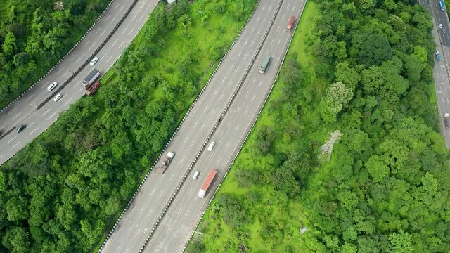 Flyby drone over three parallel roads passing through the Jungles of the Western Ghats of India