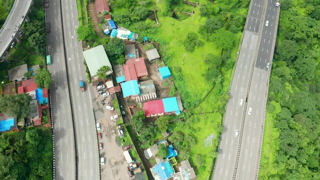 Expressway roads passing through countryside houses as they connect big cities of Mumbai and Pune