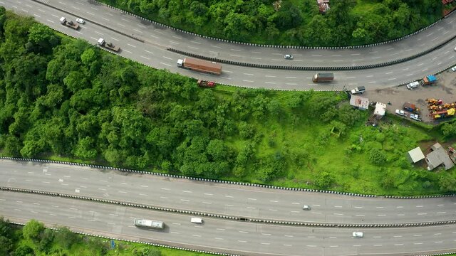 Flyby sideways over two parallel expressway roads as the traffic zooms past