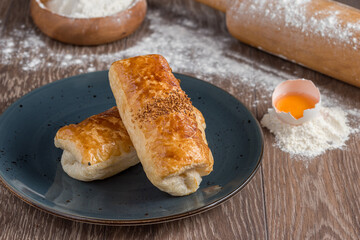 Traditional Turkish Borek or Turkish pastry with minced meat, cheese and spinac on wooden background