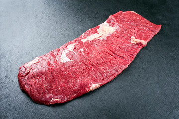 Raw wagyu bavette beef steak offered as top view on rustic black board with copy space