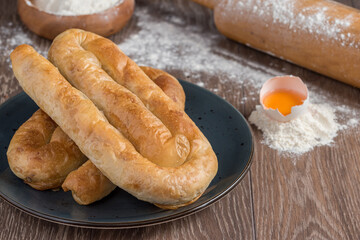 Traditional Turkish Borek or Turkish pastry with minced meat, cheese and spinac on wooden background
