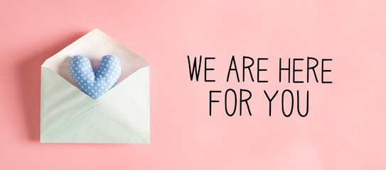 We are Here for You message with a blue heart cushion in an envelope