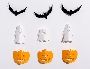 Halloween theme with paper craft decorations on a white background