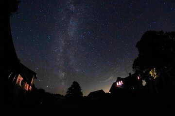 Blue dark night sky with many stars. Night sky over rural landscape. high ISO landscape with...
