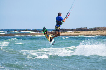 Salto en el agua haciendo kitesurf