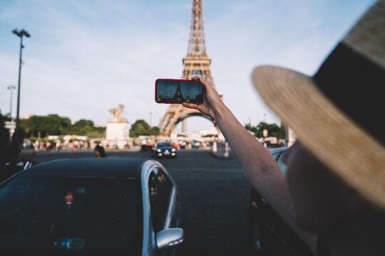 Female tourist taking pictures from road