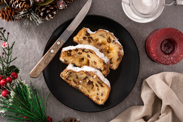 Christmas stollen fruit cake slice on gray stone.Top view