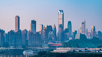 Fototapeta premium Night view of tall buildings along Chaotianmen in Chongqing, China and Chongqing Grand Theater