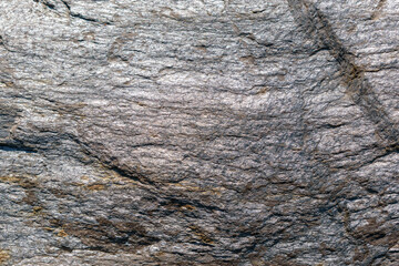 Surface of gold-antimony ore. Olimpiada deposit, Krasnoyarsk Territory. Mineral composition - gold, sulfides, quartz, mica, antimonite. Shine.