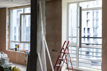 Home renovation in room full of painting tools