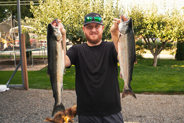 man holding catch of the day salmon 