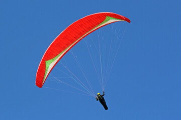 Paraglider flying wing in a blue sky	