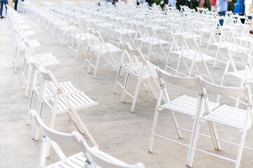Rows of empty metal chair seats installed for some business event or performance,festival