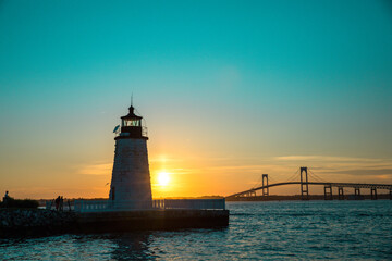 Sunset over Newport Harbor Lighthouse with bridge and colorful sky