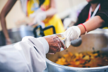 Concept of food donation : Homeless and needy people receive help, receive food from volunteers