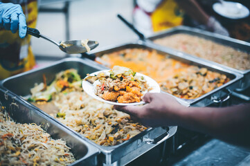 Concept of food donation : Homeless and needy people receive help, receive food from volunteers