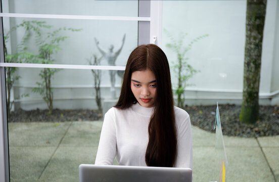 Asian Business Women Typing Keyboard Insert Data To Laptop At Office. Business People Working At Home With Internet.