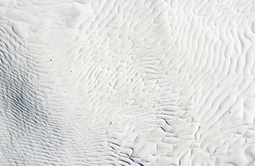 Pamukkale white travertine background with relief texture of waves and lines