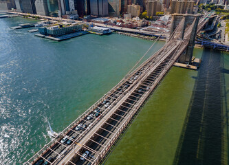 Drone flying close to over the Brooklyn bridge in Manhattan New York City USA during summer time