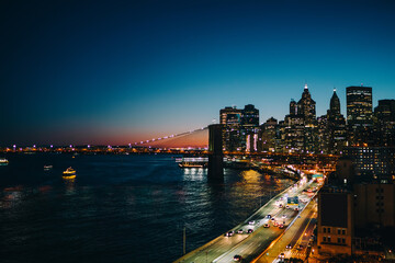 Suspension bridge and modern city in night lights