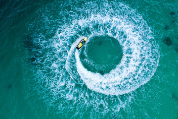 People are playing a jet ski in the sea.Aerial view. Top view.amazing nature background. The color of the water and beautifully bright.