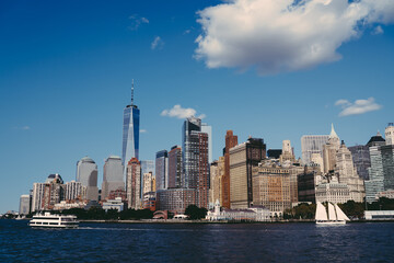 Fototapeta na wymiar Urban Manhattan skyscrapers on seafront with flowing river