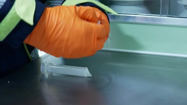 The paramedic is getting ready IV treatment from IV ampule