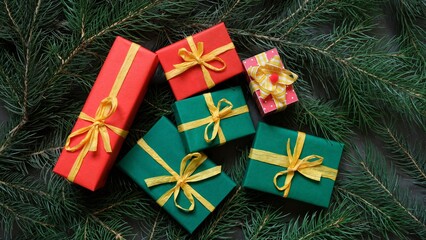 Colorful Christmas gifts tied with yellow ribbon. Christmas composition. The view from the top.