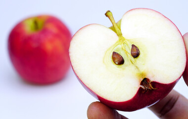 Half an apple in a man's hand.
