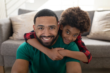 Fototapeta premium Portrait of father and son at home
