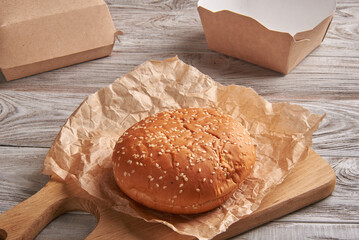 The burger buns on wooden background.