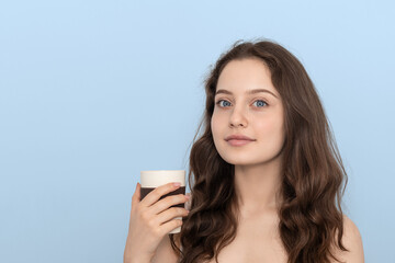 A young girl with reusable bamboo cup.