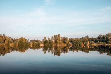 autumn trees reflected in water