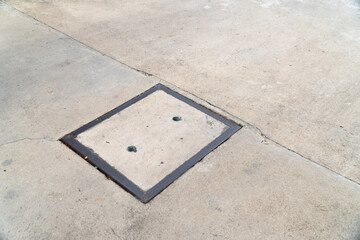 Fototapeta premium Manhole cover on concrete street.