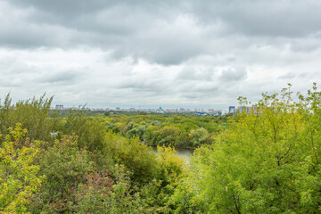Fototapeta na wymiar City view from Kolomenskoye park on a cloudy day. Moscow, Russia