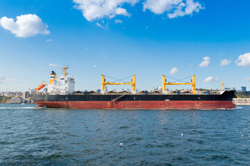 Commercial cargo ship going through the Bosphorus Strait in Istanbul, Turkey. Background for import, export cargo, industry logistic.