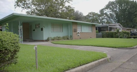Rack focus from street: Civil rights leader Medgar Evers home. Site of his assassination. Jackson, Mississippi.