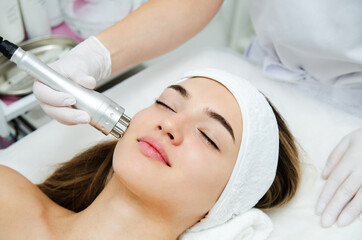 Woman getting ultrasound face beauty treatment in medical spa center