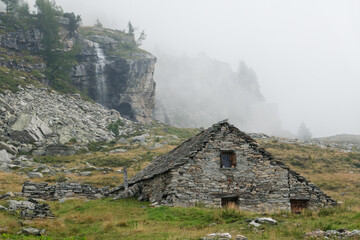 Traditional farmhouse built from boulders found on site, Schwarzi Balma, Wallis, Switzerland © Matauw