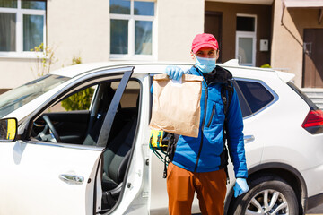 contactless food delivery to customers home. Delivery service worker with thermal backpack quick...