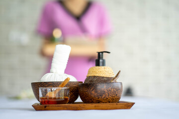 coconut oil aromatherapy for facial massage spa with salt and traditional oriental herbs on bed getting spa massage facial service