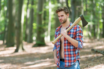Managing forest. Handsome guy carry chopping axe in wood. Tree chopping. Forestry logging....