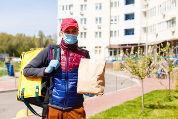 delivery man send food bag for contactless or contact free from delivery rider in front house for social distancing for infection risk.
