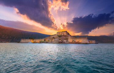 Obraz premium View of the island of Spinalonga with calm sea. Here were isolated lepers, humans with the Hansen's desease, gulf of Elounda, Crete, Greece. 