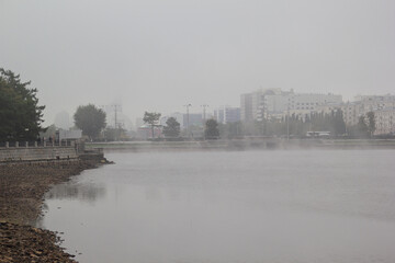 city embankment in the fog