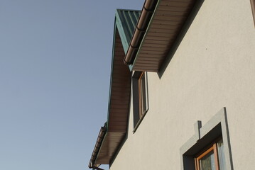 gray facade of the house on a background of the sky