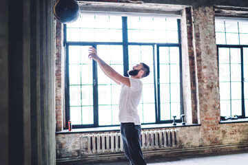 Focused man playing basketball in gym