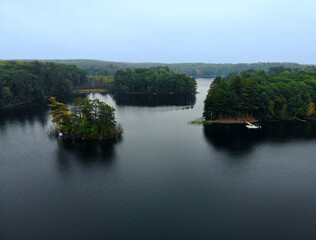 An aerial view of rural Northern Wisconsin forest, cabins and lake