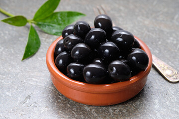 Tasty black olives in the bowl